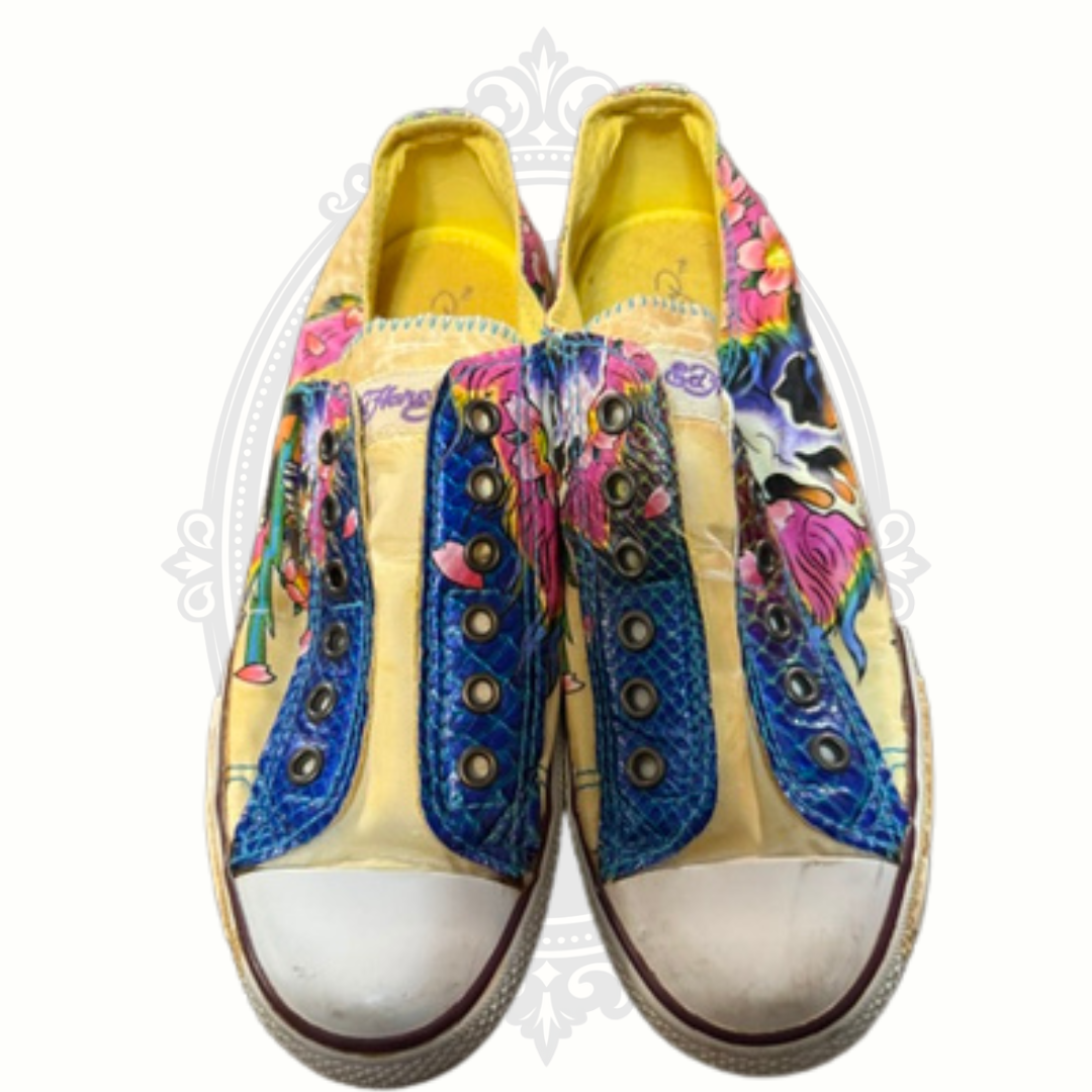 Front view of Ed Hardy sneakers with white rubber toe caps and vivid skull design
