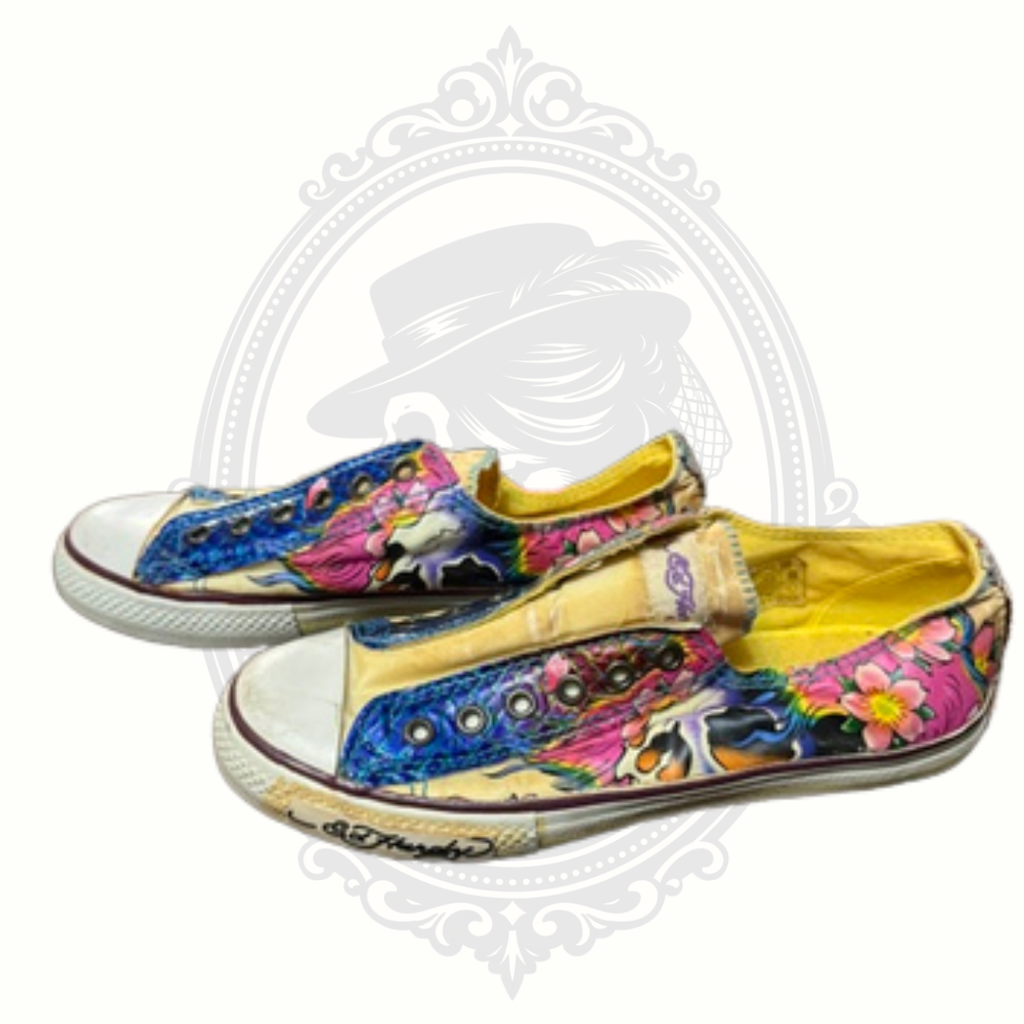 Side view of Ed Hardy sneakers featuring vibrant tattoo-style skull artwork and floral details