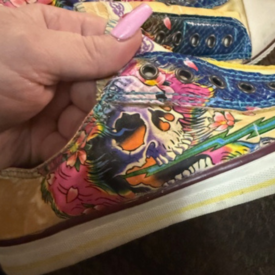Close-up of Ed Hardy sneaker showing detailed colorful skull and tattoo-style artwork