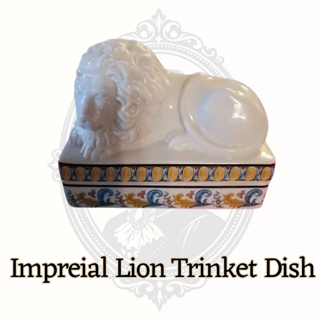 Angled left view of Elizabeth Arden lion trinket dish showing decorative base detail