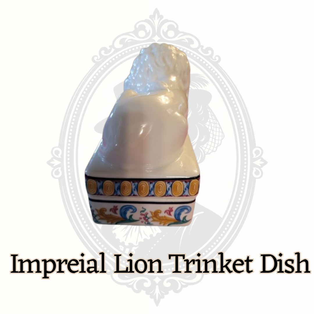 Right angled view of lion trinket dish showing ornate multicolor base pattern