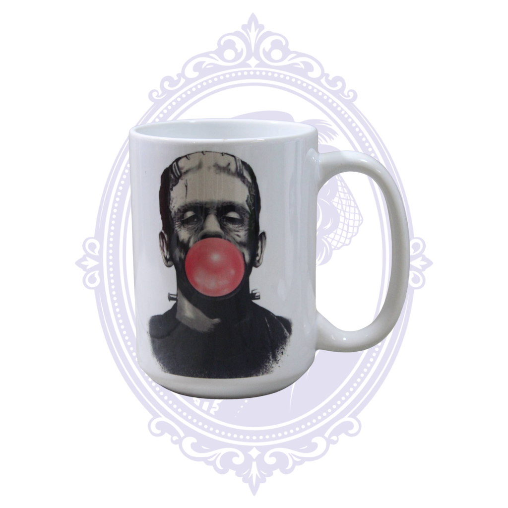 Frankenstein’s Monster blowing a pink bubblegum bubble on a white 15 oz classic horror coffee mug.