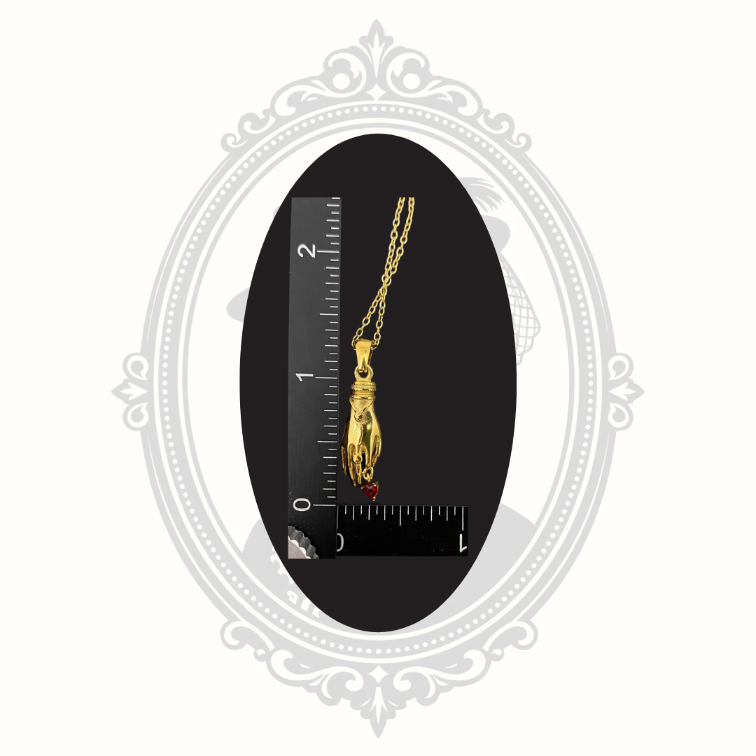 Gold-plated fortune hand pendant necklace shown beside a ruler for size reference.
