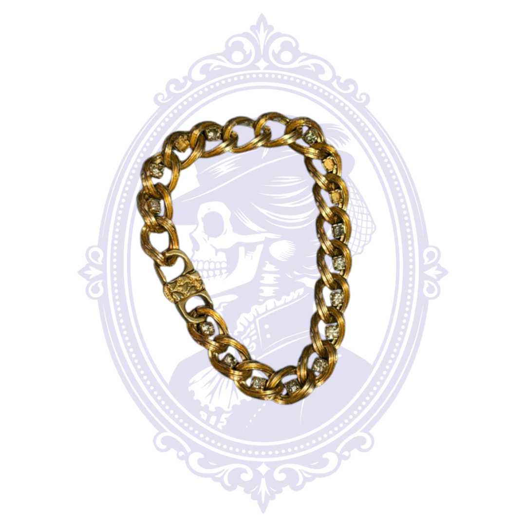 Gold-tone curb chain bracelet with clear rhinestone accents shown in full.