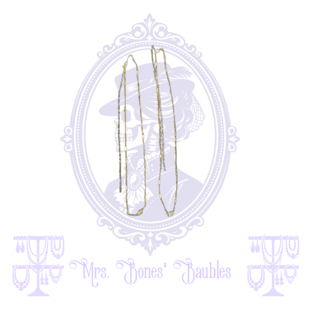Detail view of two inexpensive gold-tone fashion necklaces being sold together as a pair.