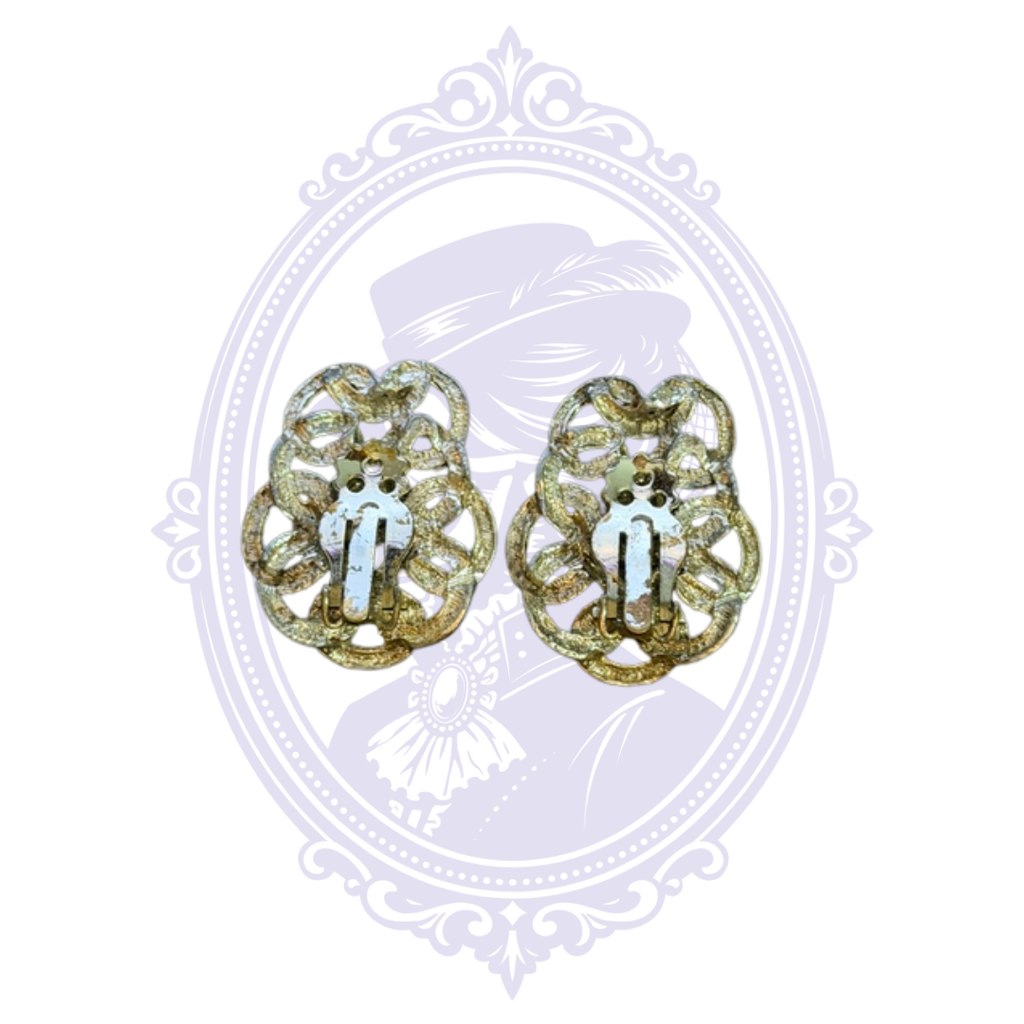 Back view of gold-tone filigree clip-on earrings showing the hinged clip mechanisms for non-pierced ears.