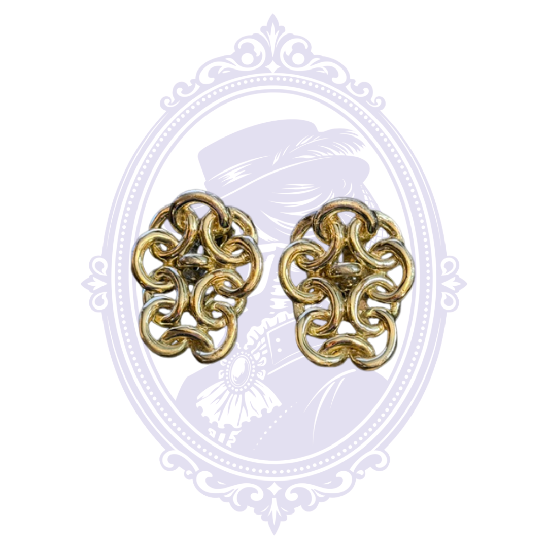 Pair of gold-tone filigree scroll clip-on earrings with ornate openwork design.