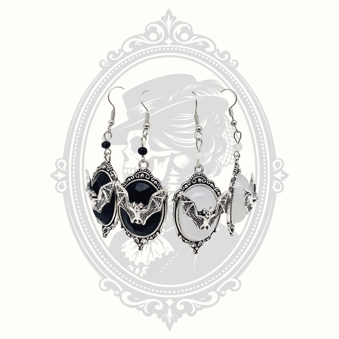 Gothic bat cameo drop earrings shown in black and white gemstone styles.