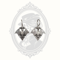 Silver-tone Gothic bat huggie earrings with intricate filigree wings.