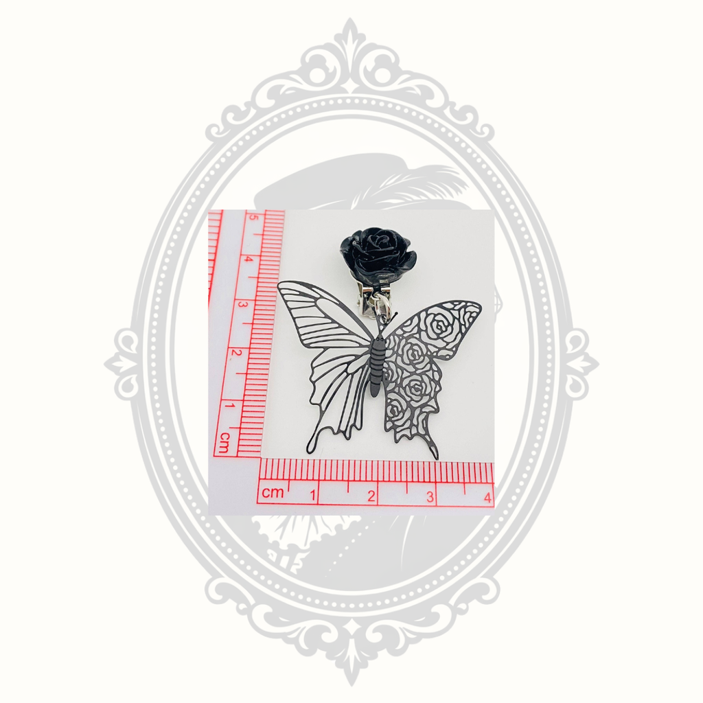 Gothic butterfly clip-on earring shown beside a ruler for size reference.