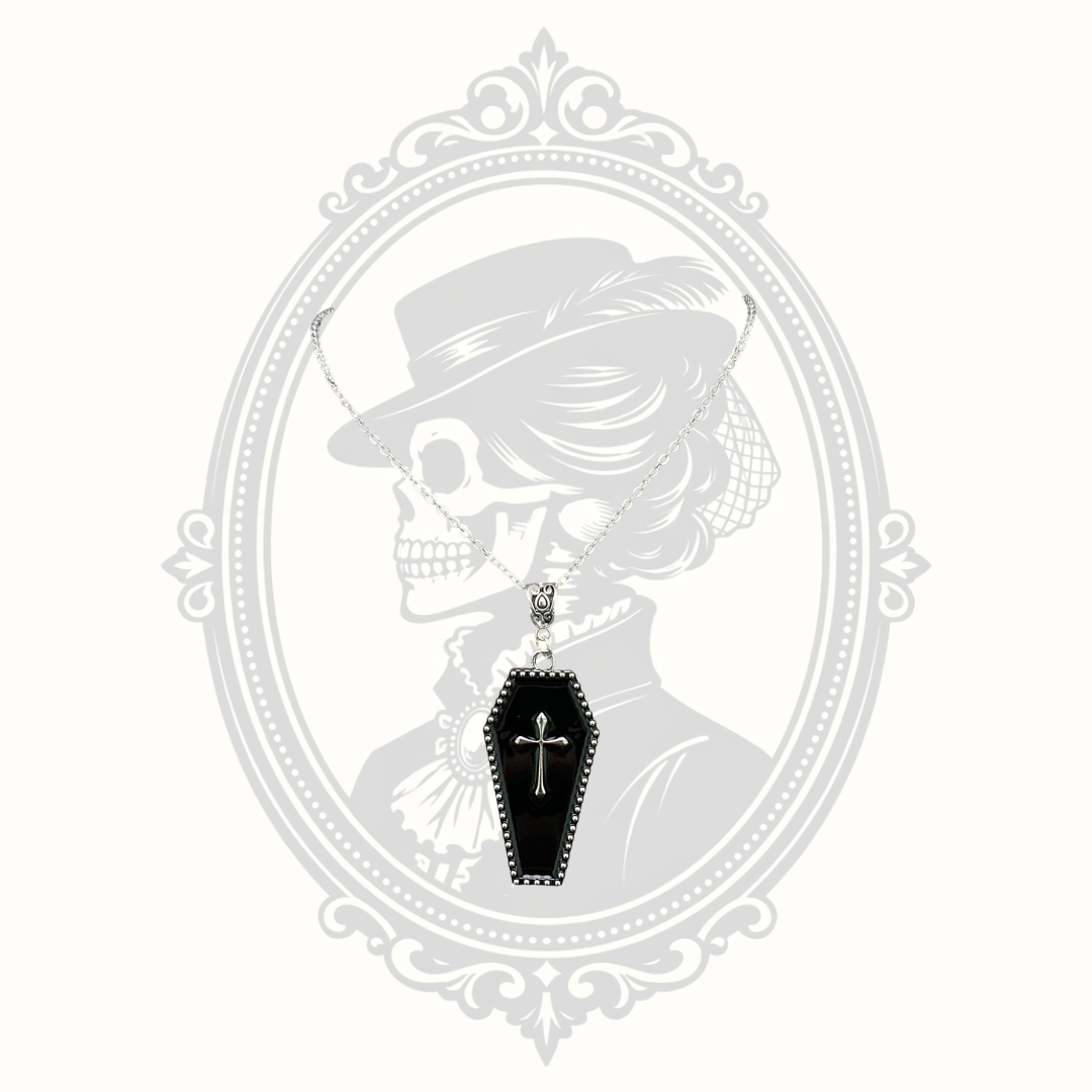 Black enamel Gothic coffin pendant necklace with raised silver-tone cross.