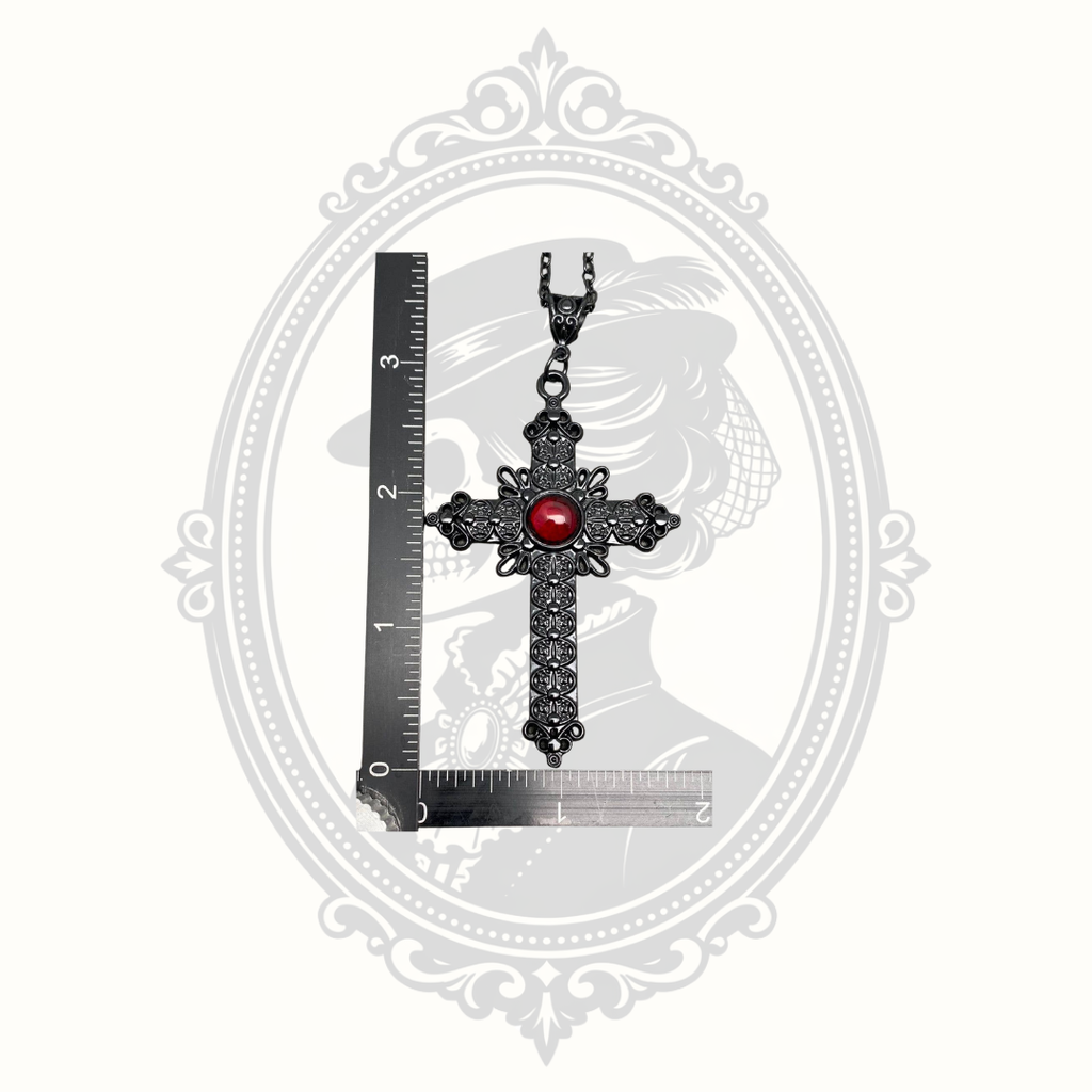 Gothic cross pendant beside ruler showing approximate size.