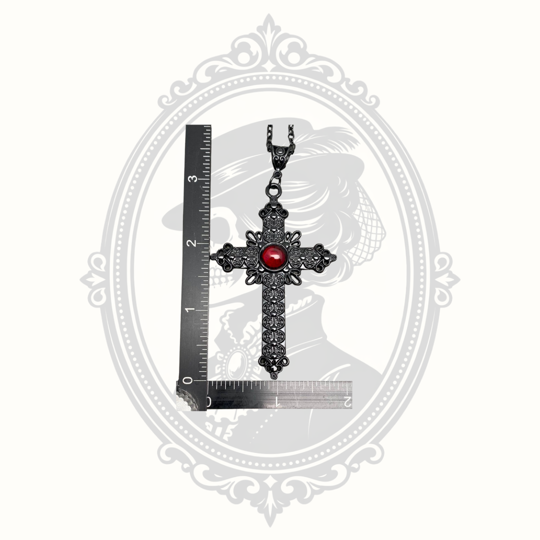 Gothic cross pendant beside ruler showing approximate size.