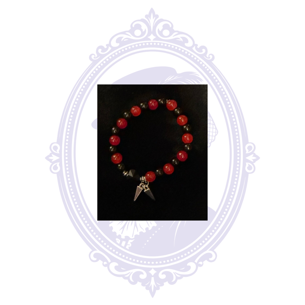 Gothic red beaded bracelet with dark spacer beads, black accent bead and dangling spike charms.