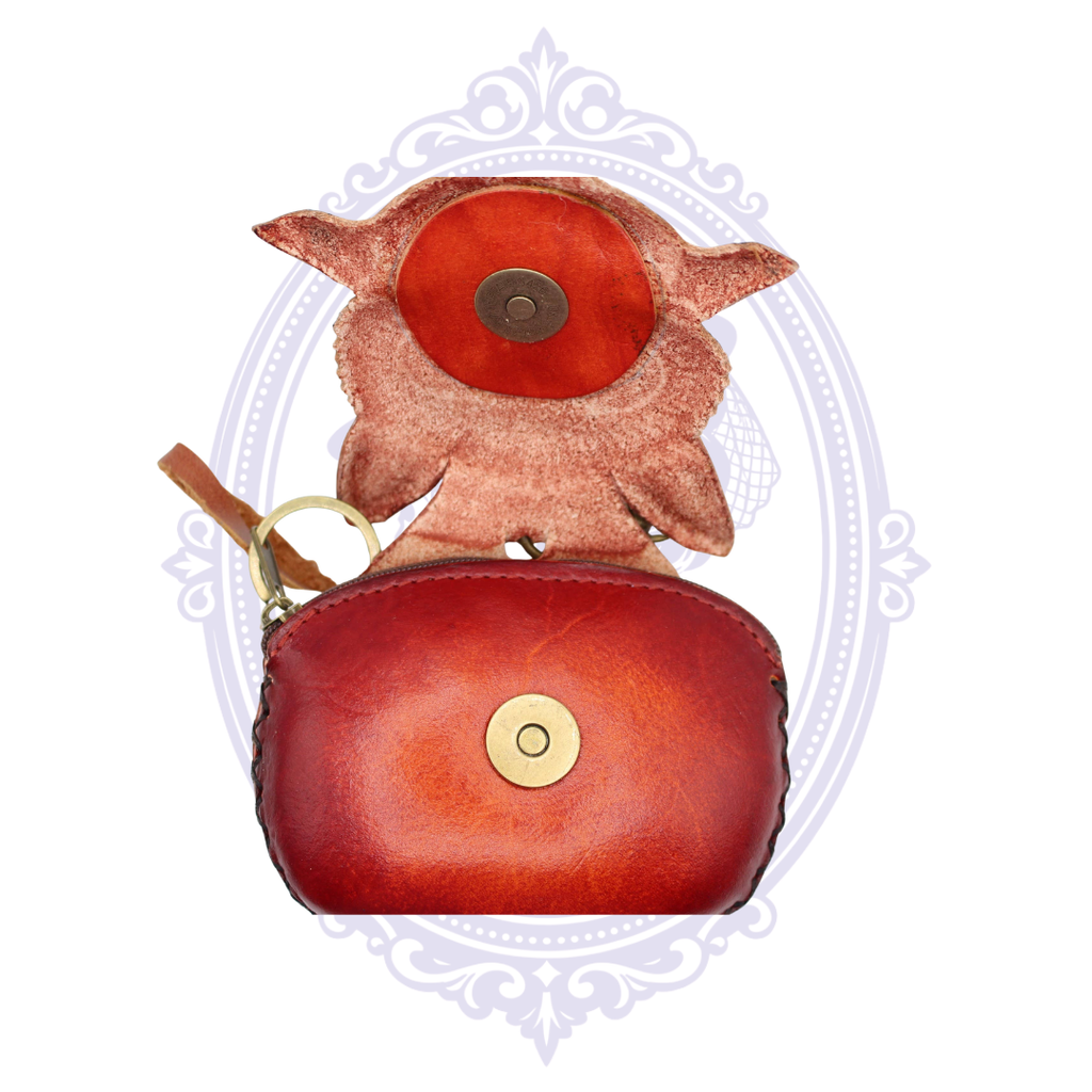 Handmade leather baby bat coin purse wristlet shown open with magnetic snap closure and red leather interior