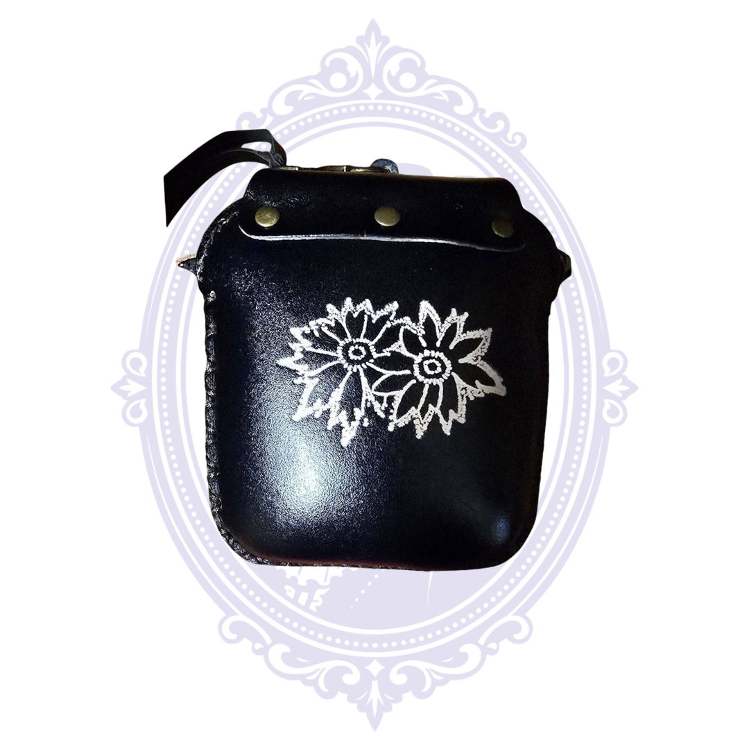 Back of handmade black leather bat coin purse wristlet with floral decorative detailing