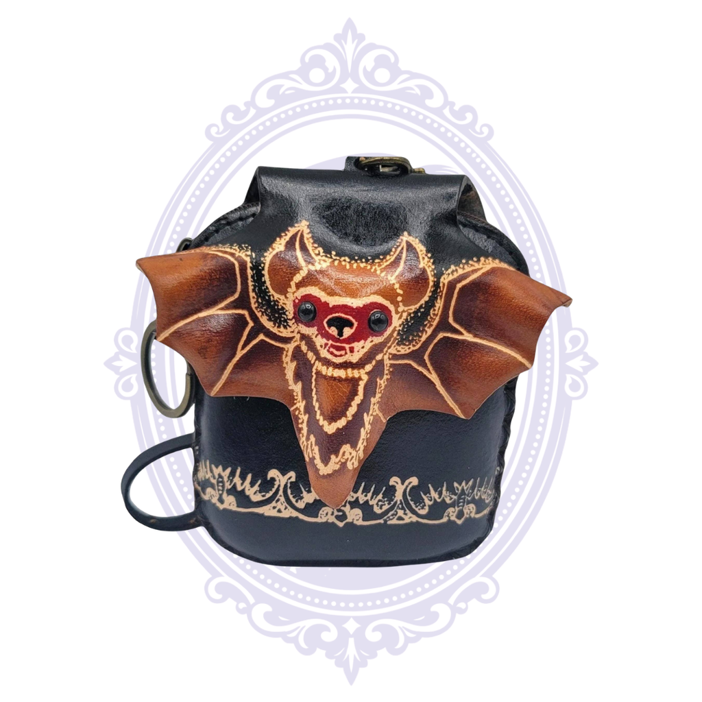 Close front view of handmade leather bat wristlet coin purse showing dimensional hand-tooled bat design