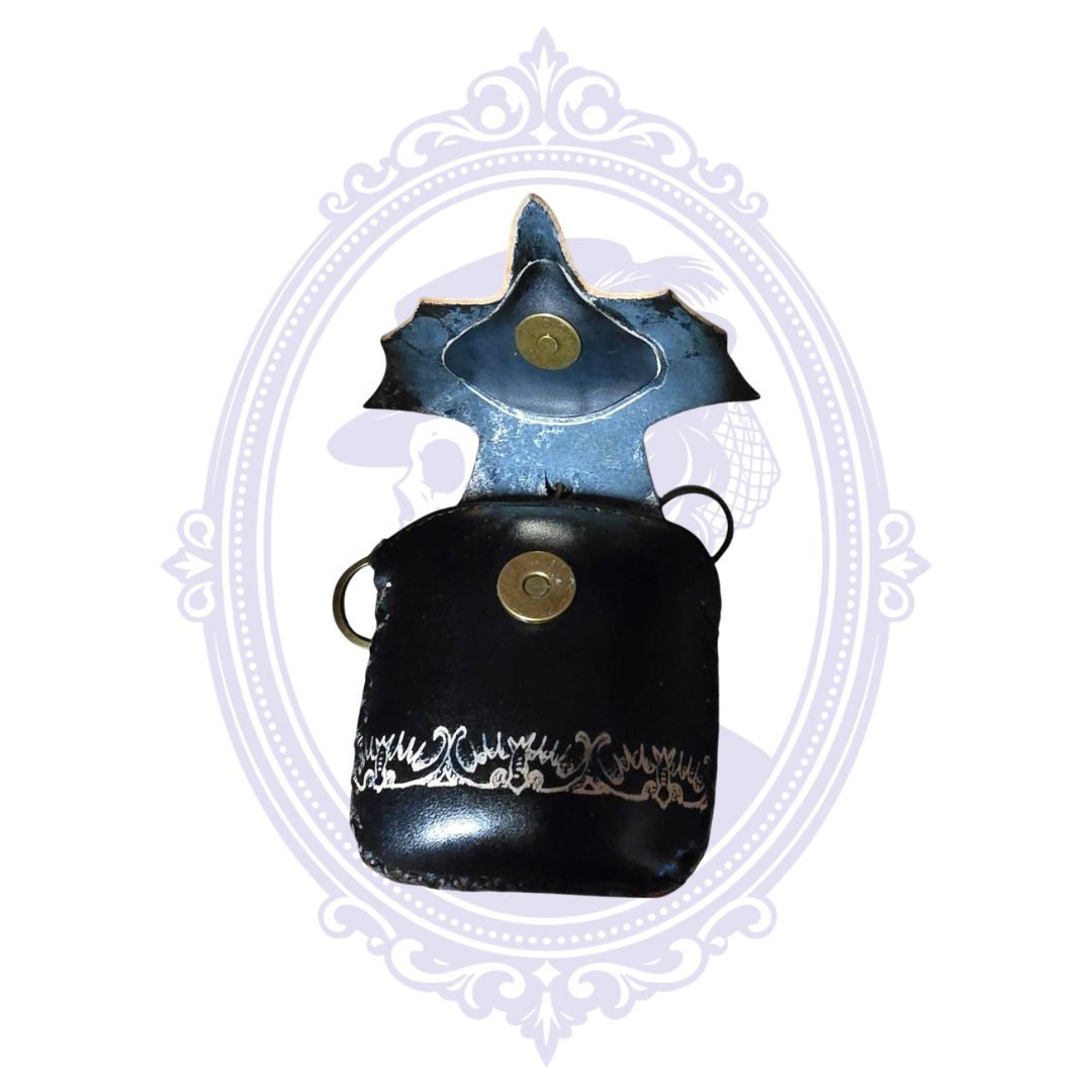 Handmade leather bat coin purse wristlet open to show magnetic snap closure and interior compartment