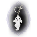 White handmade ghost keychain with curved ghost shape, black painted face, and silver-tone clip and keyring.
