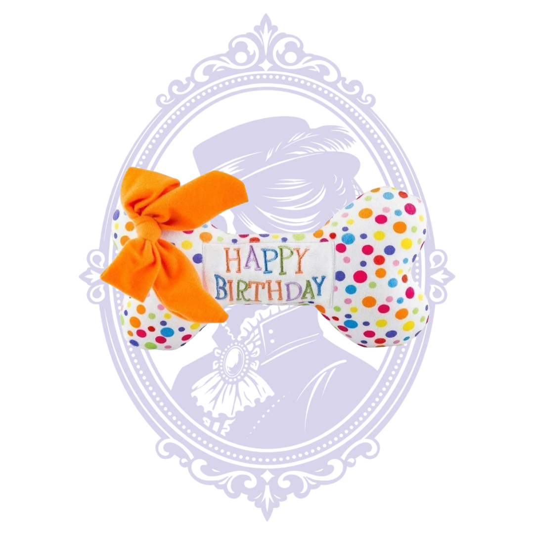 Happy Birthday plush bone with multicolored dots and orange bow