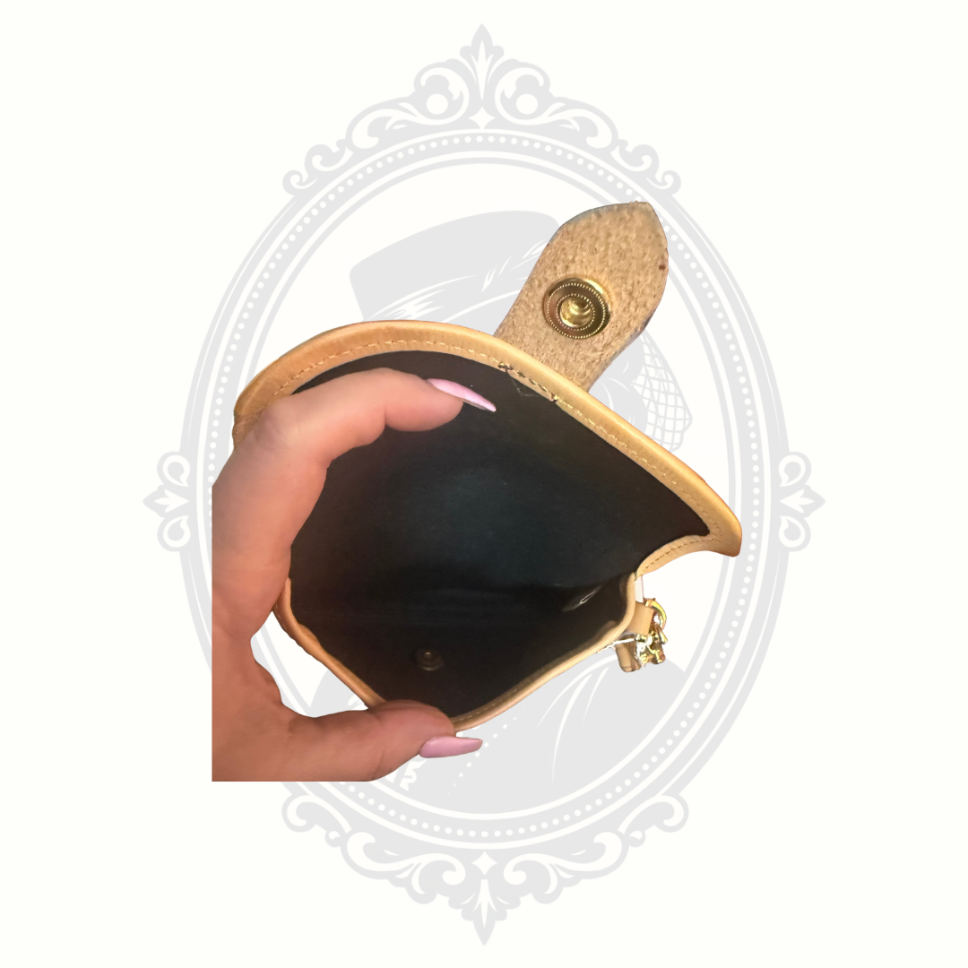 Interior of Dooney & Bourke wristlet showing clean black lining and snap closure