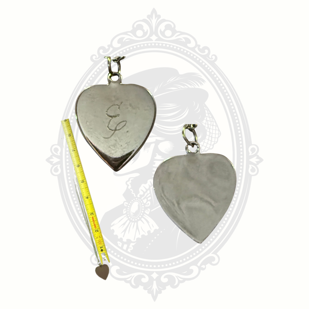 Close-up of engraved heart pendant showing initial E detail
