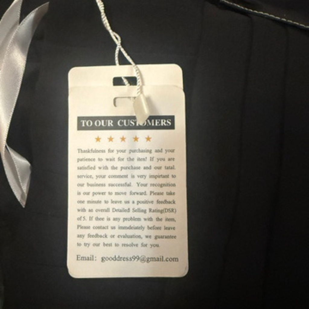 Clothing tag with customer feedback request on a black garment