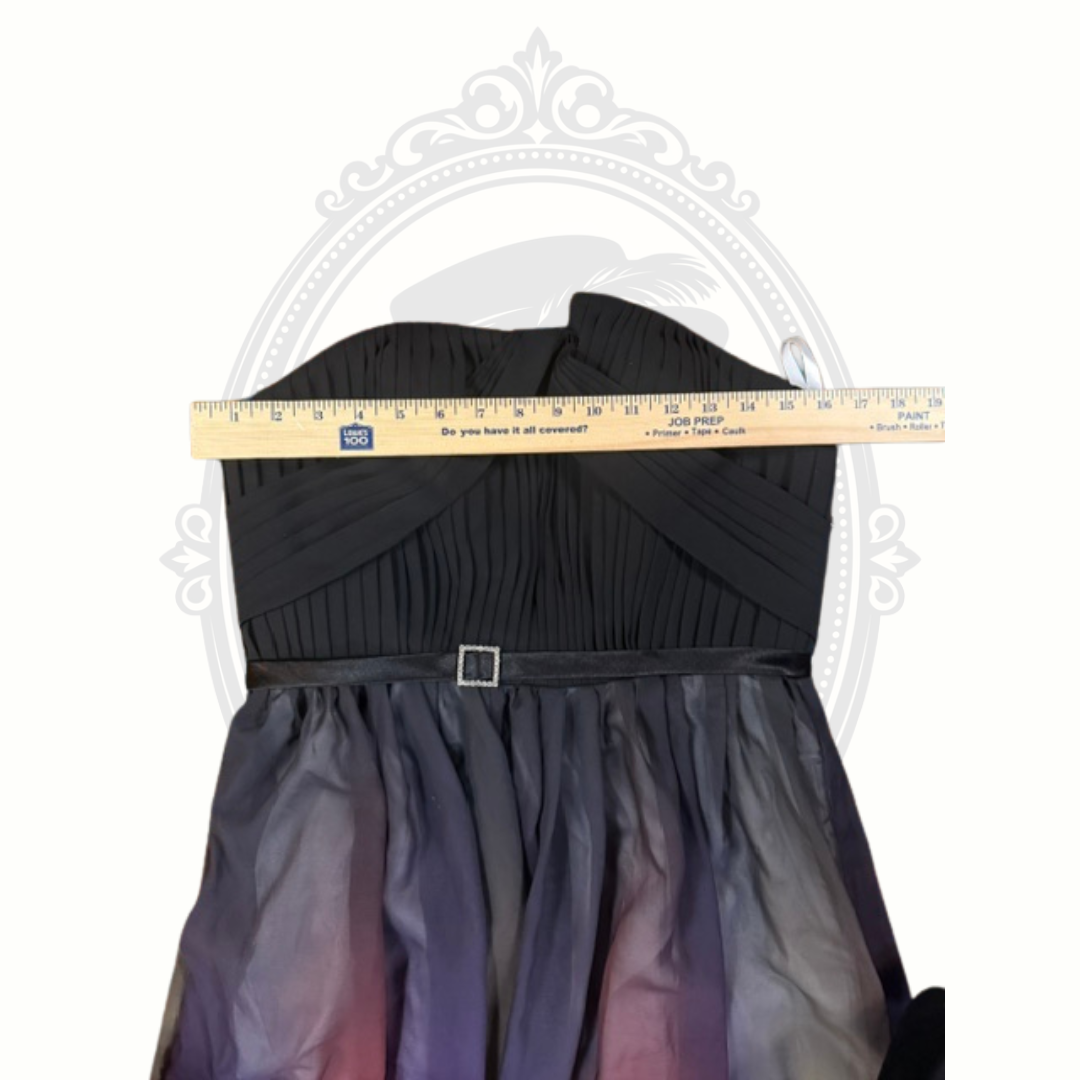 Black dress with a gradient skirt and a ruler for size reference on a white background