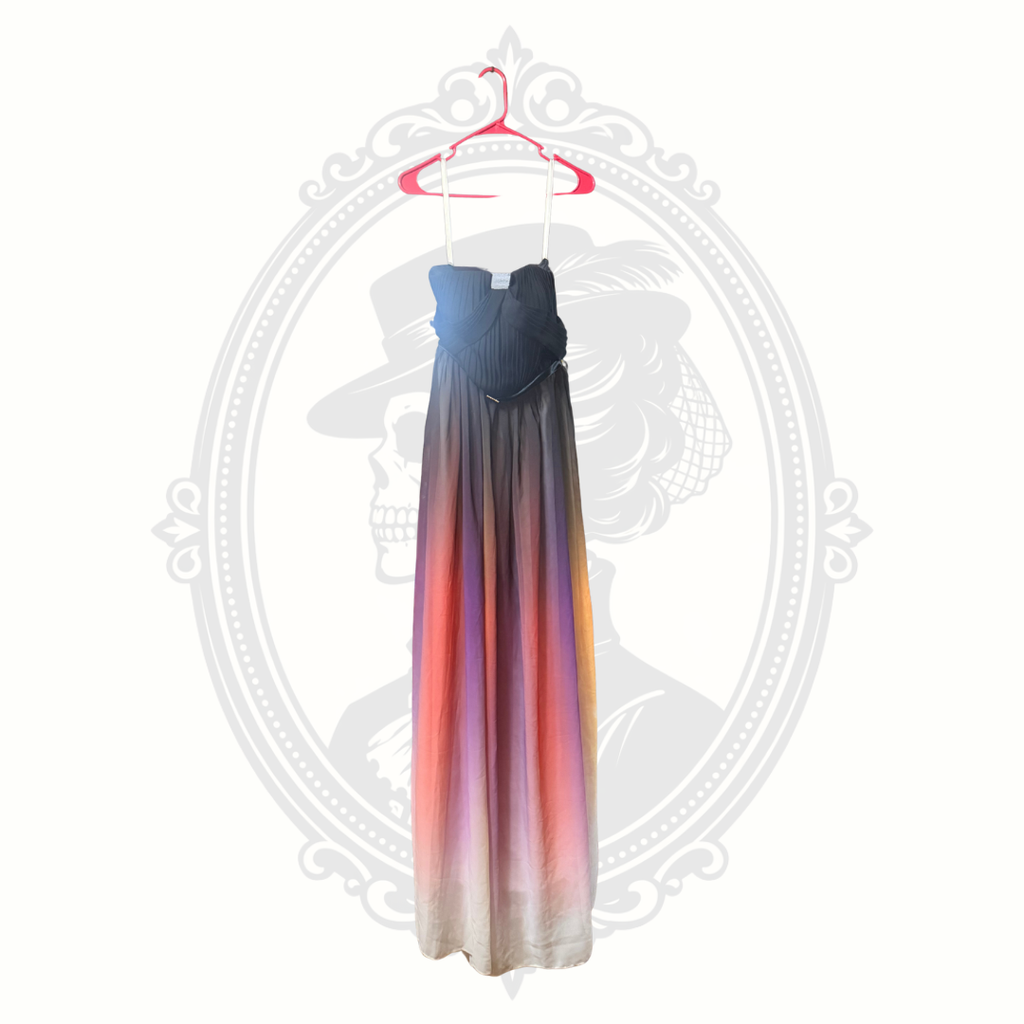 Long dress with gradient colors on a hanger against a white background