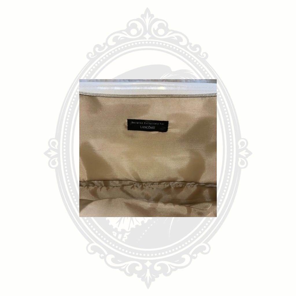 Interior label and lining detail inside metallic gold Lancôme makeup bag