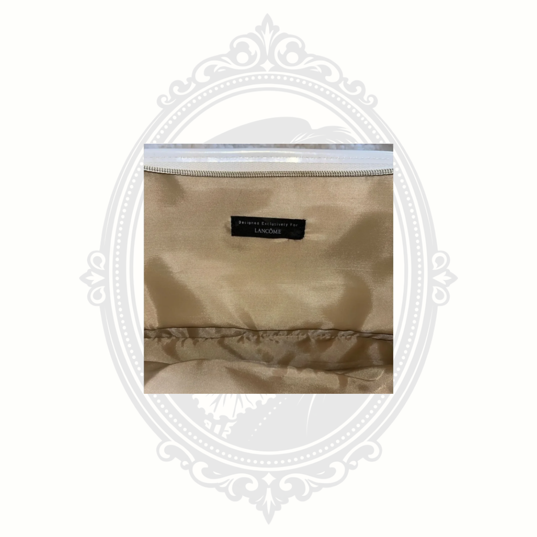 Interior label and lining detail inside metallic gold Lancôme makeup bag
