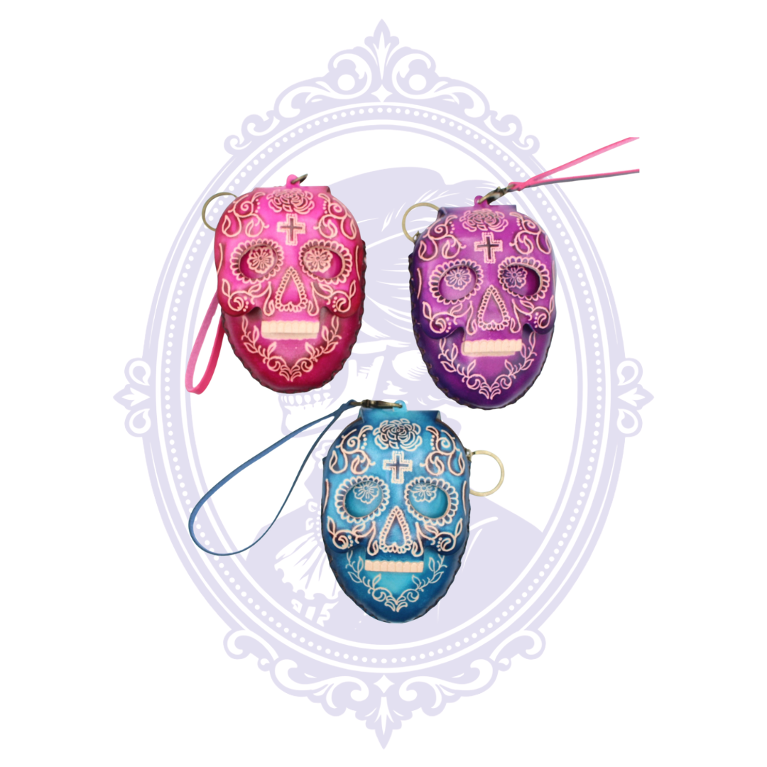 Assorted pink, purple and blue leather sugar skull coin purses with wrist straps and key rings.