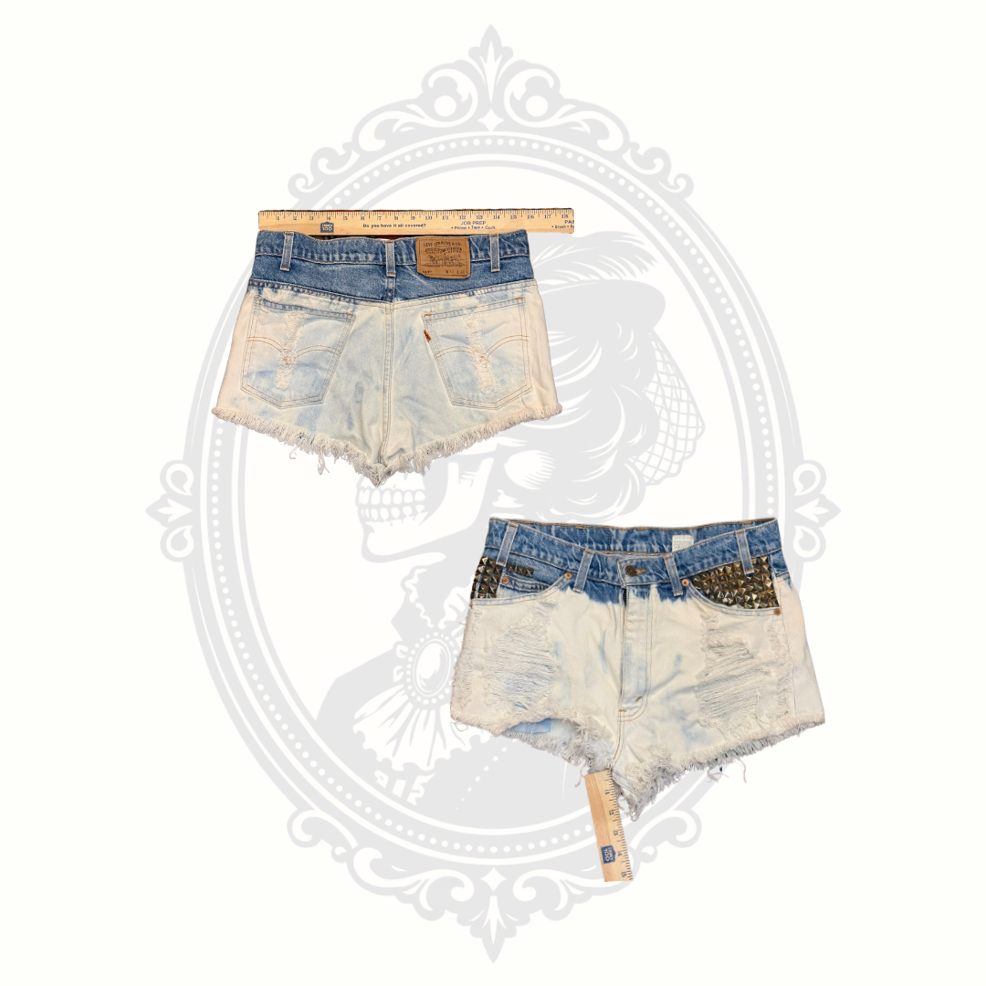 Front and back measurement view of vintage Levi’s 517 studded denim shorts with distressed detailing and cutoff styling.