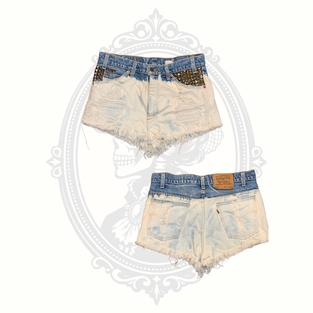 Front and back views of Levi’s 517 studded distressed denim cutoff shorts