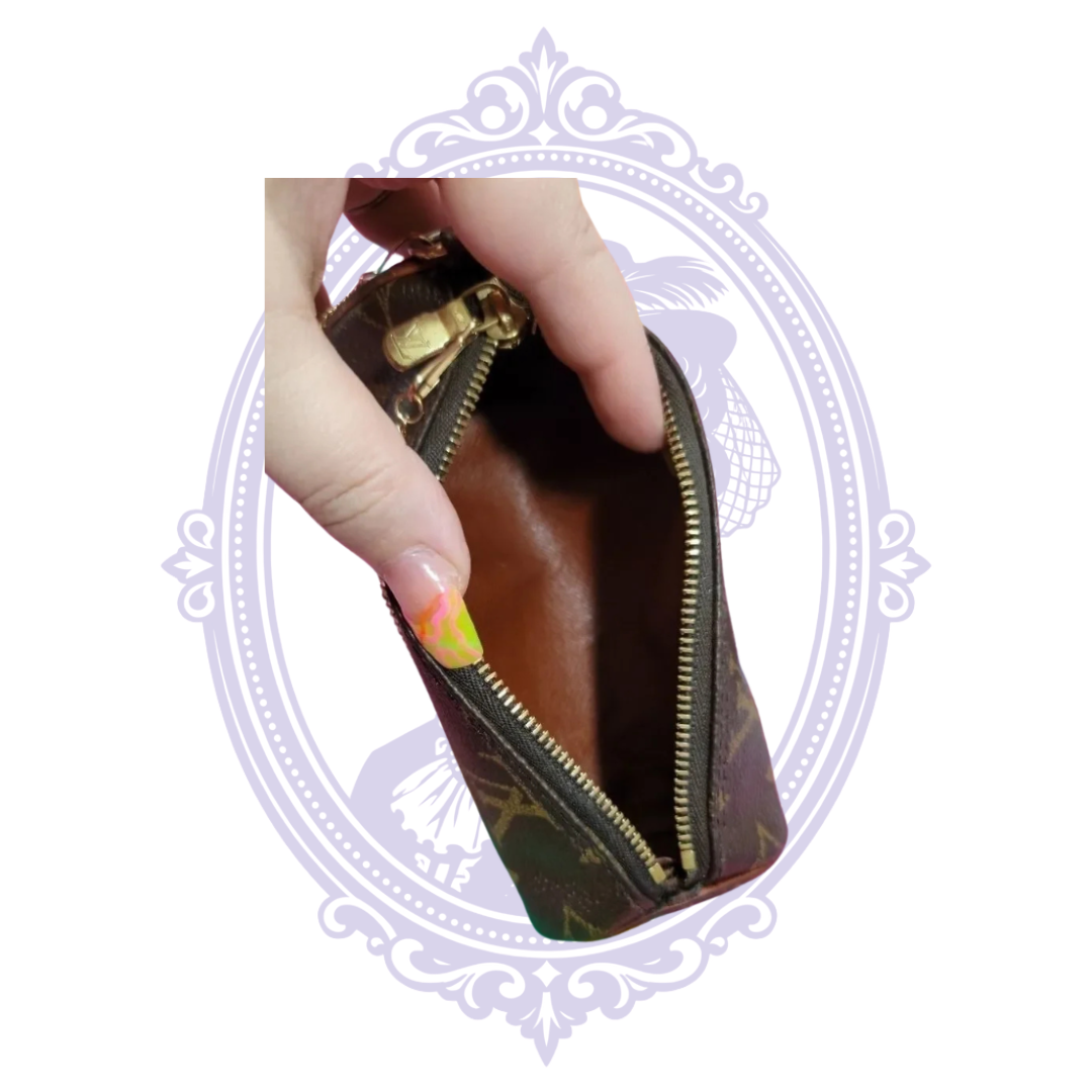 Open Louis Vuitton Papillon mini pochette showing brown interior
