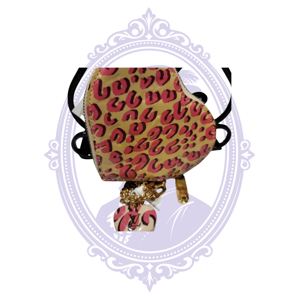 Louis Vuitton leopard heart coin purse shown with chain and authenticity tag
