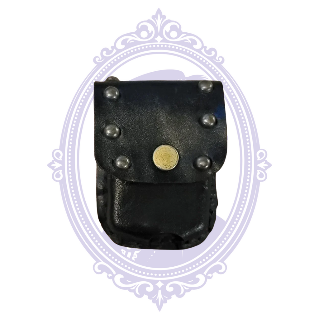 Front of black leather mini pouch with six silver-tone studs and brass-tone snap closure