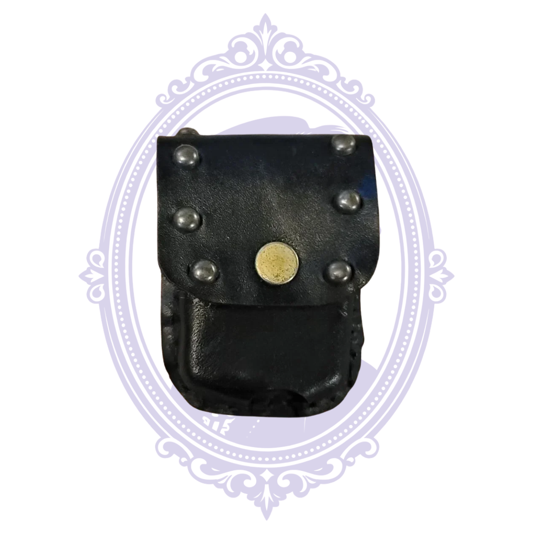 Front of black leather mini pouch with six silver-tone studs and brass-tone snap closure
