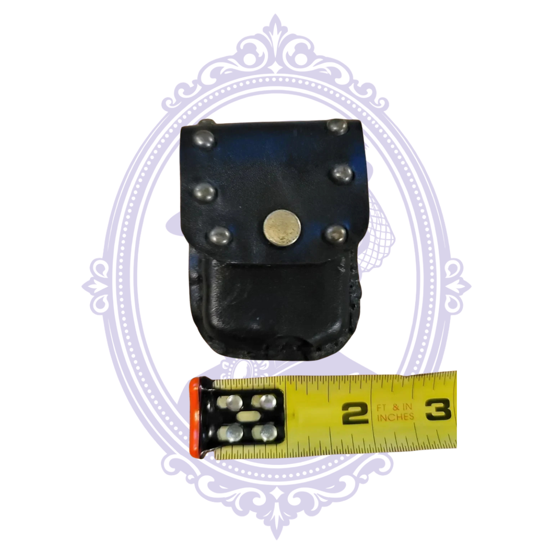 Back of black leather mini pouch showing wide belt loop and stitched lower edge