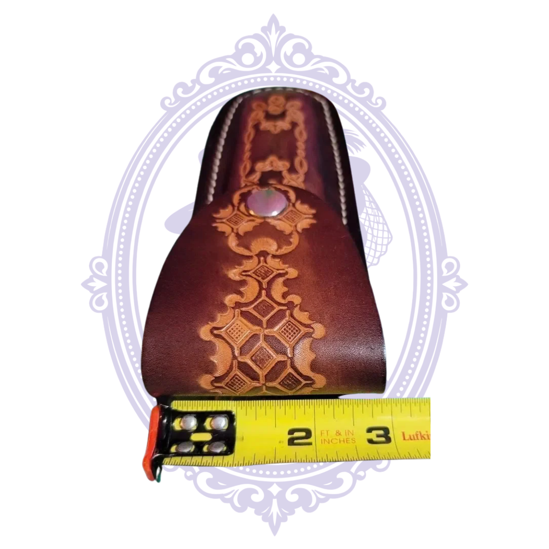 Close-up of tooled leather flap and width measurement
