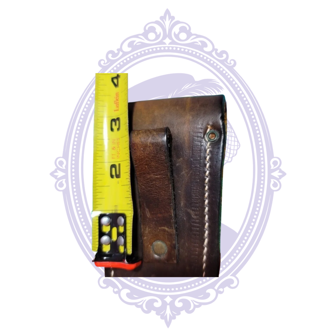 Back view of vintage brown leather belt sheath showing stitched edges and leather belt loop