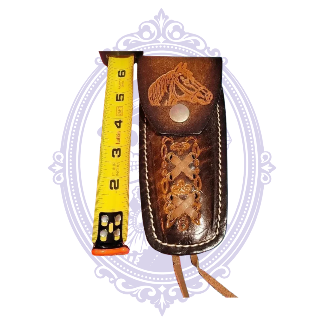 Horse-head leather sheath alongside tape measure showing approximate length