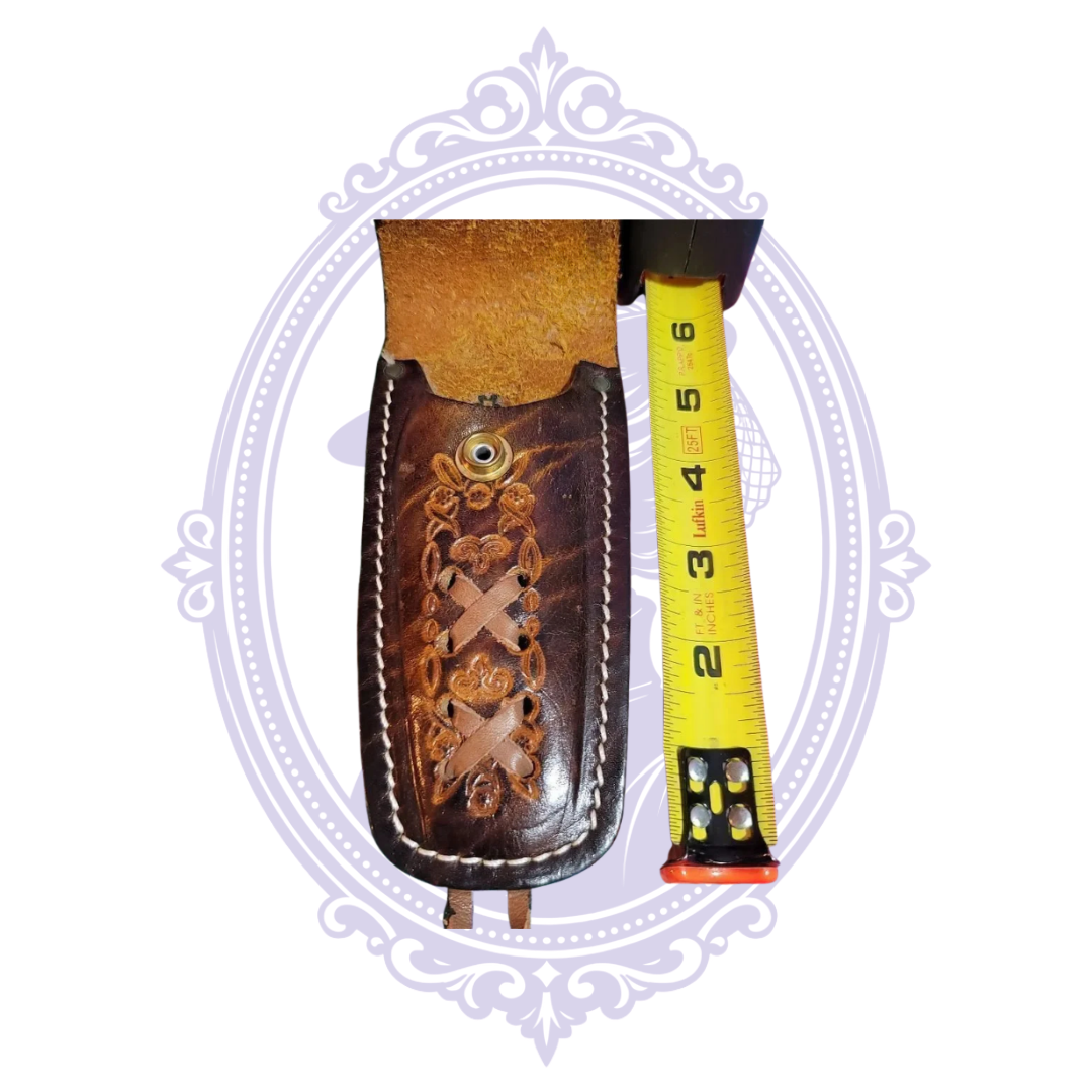 Open leather sheath with floral tooling and tape measure