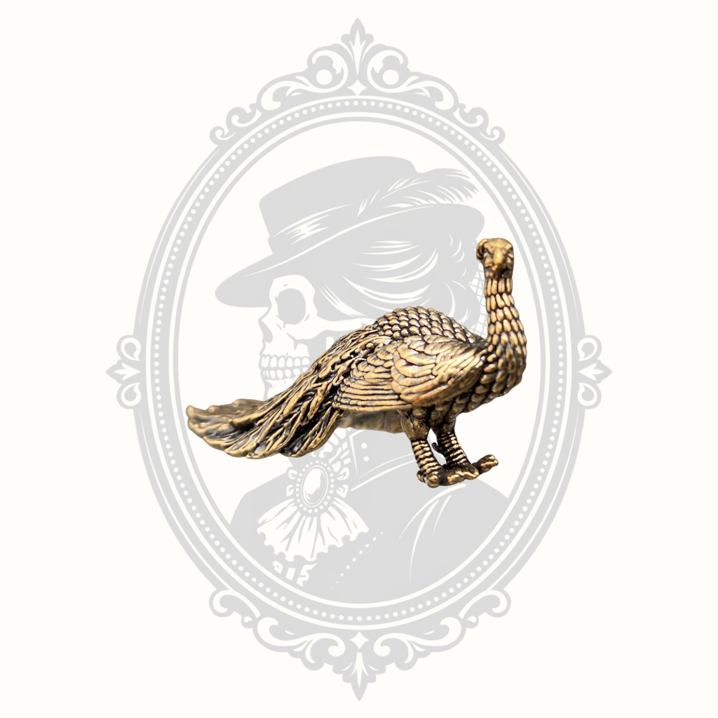 Miniature solid brass peacock desktop ornament displayed from the front.