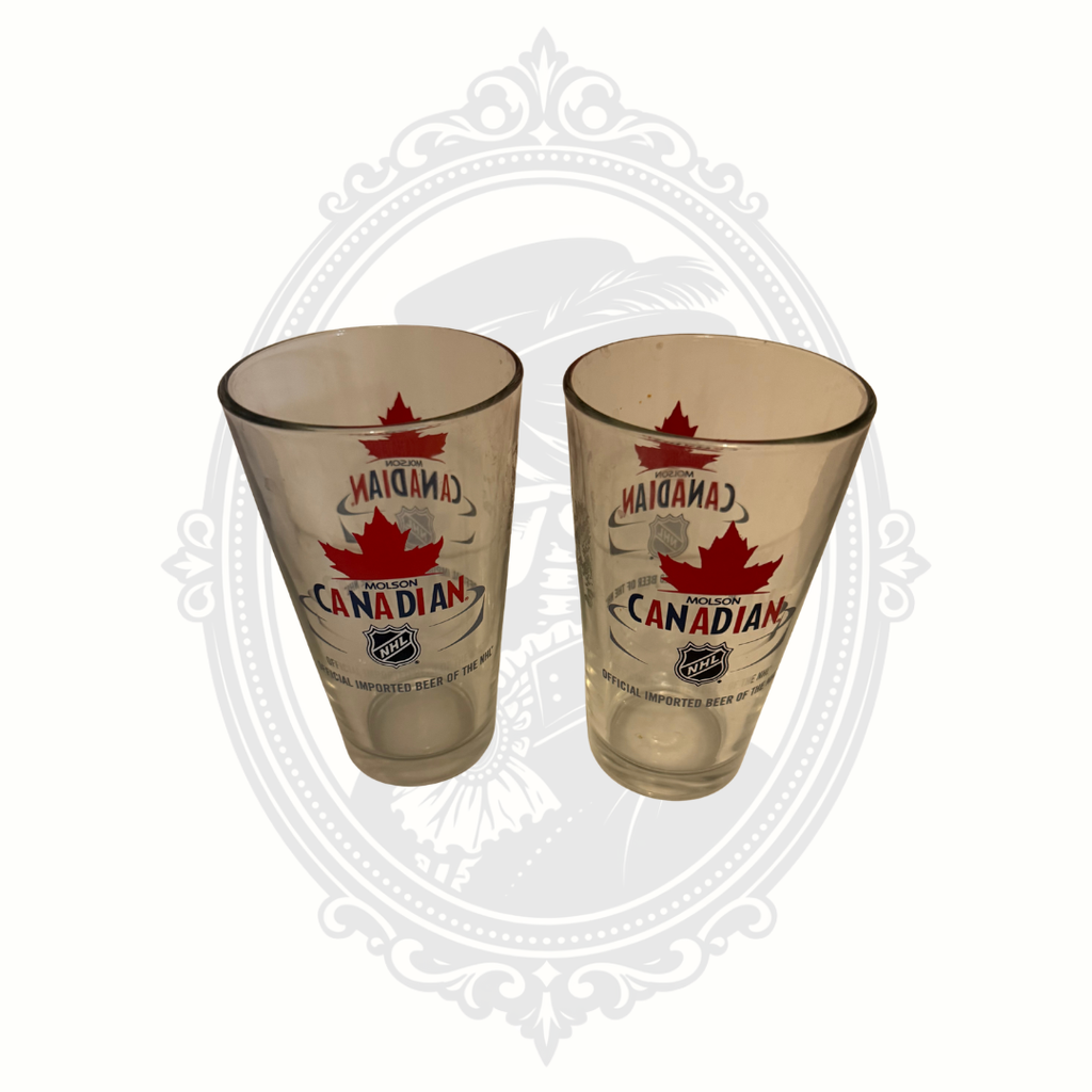 Close angled view of vintage-style Molson Canadian NHL pint beer glasses.