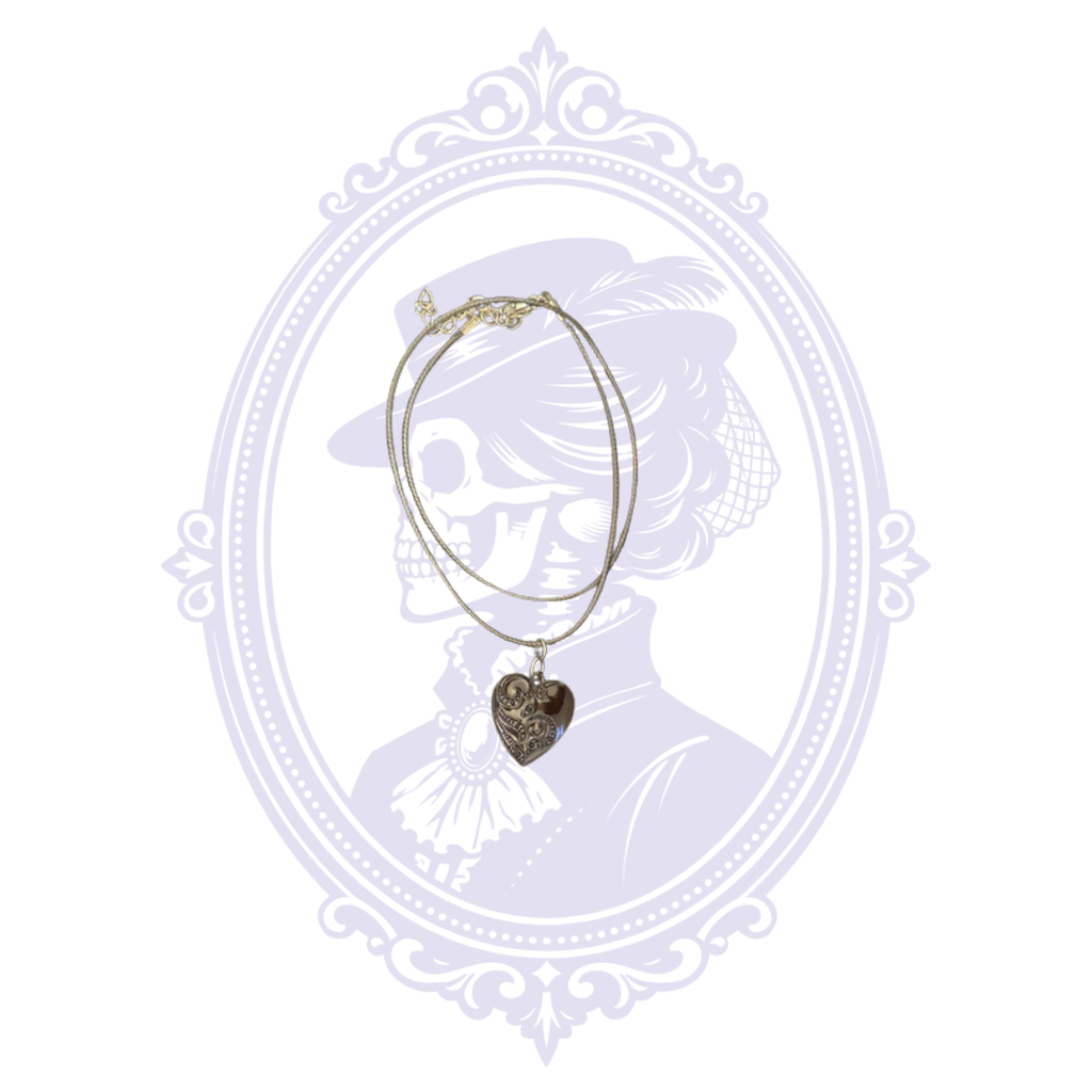 Monochrome black ornate heart gothic necklace shown with black cord and decorative heart pendant