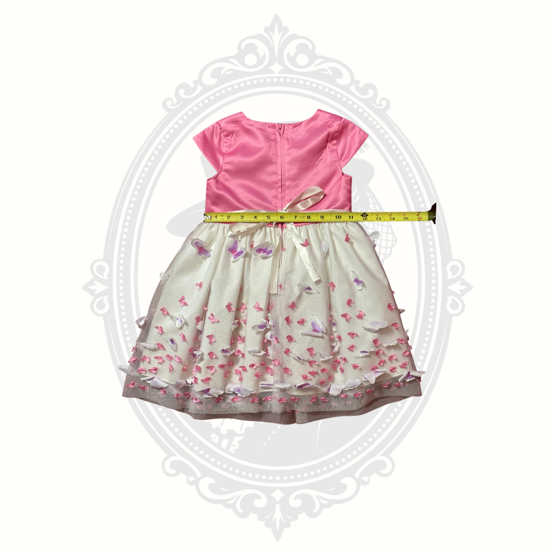 Waist detail of pink butterfly dress showing gathered waistband and layered skirt design.