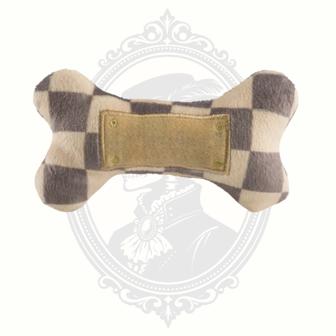 Alternate view of checkered plush bone dog toy showing textured fabric and stitched panel detail