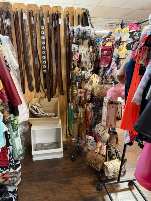 Clothing, vintage belts, jewelry and handbags displayed inside Mrs. Bones Curio Cupboard Booth 386 at Treasure Trove Fleatique.