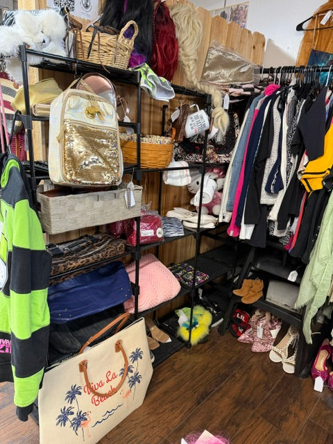 Clothing, handbags, shoes and accessories displayed inside Mrs. Bones Curio Cupboard Booth 386 at Treasure Trove Fleatique.